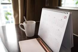 desk calendar next to coffee cup